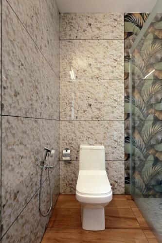 a bathroom with a toilet and a shower at Kerala cottage in Varkala