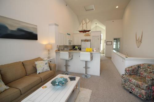 a living room with a couch and a table at Cambridge Cove at Bermuda Bay by Kees Vacations in Kill Devil Hills