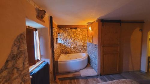 a bathroom with a bath tub and a sink at B&B XXIV Maggio in Rocca di Botte