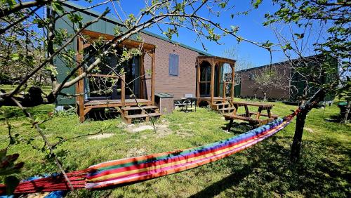 a hammock in front of a house in a yard at Calla Retreat in Vezenkovo
