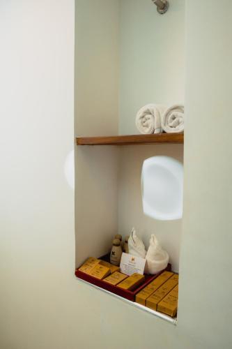 a shelf in a room with white shoes on it at Pegasus Reef - A Beach Resort in Colombo in Colombo
