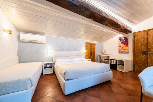 a bedroom with two beds and a desk in it at Palazzo Rivola in Bergamo
