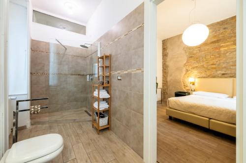 a bathroom with a bed and a toilet in a room at Palazzo Rivola in Bergamo
