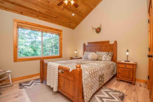 a bedroom with a wooden bed and a window at Above It All in Townsend