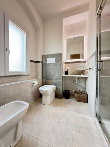 a bathroom with a toilet and a sink and a shower at Sicilia Meraviglia B&B in Fontane Bianche