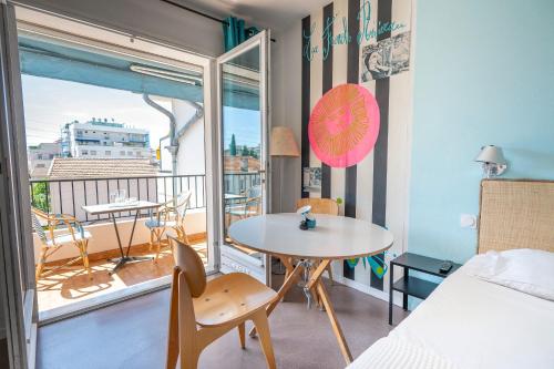 a small room with a table and a balcony at Le Val Duchesse Hotel & Appartements in Cagnes-sur-Mer