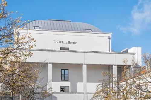 a white building with a dome on top of it at Best Western ToRVEhallerne in Vejle