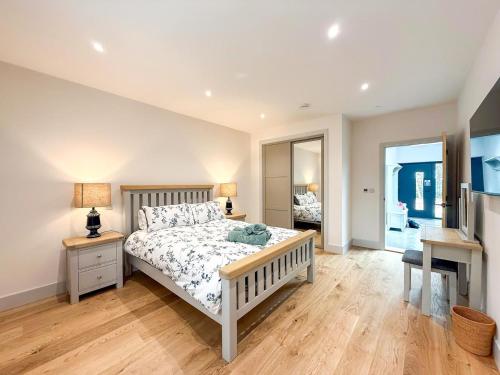 a bedroom with a bed and a desk and a television at 4 Bed in Acton oc-k40259 in Waldingfield