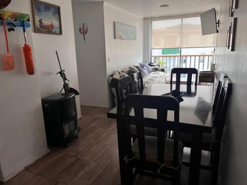 a living room with a table and a couch at Playa de Dichato in Dichato