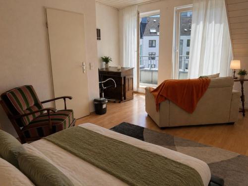 a bedroom with a bed and a couch and a desk at your accomodation in Aachen in Aachen