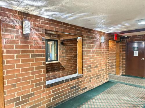 a mirror on the side of a brick wall at Plaza Hotel By OYO Calumet Park Alsip I 57 in Calumet Park