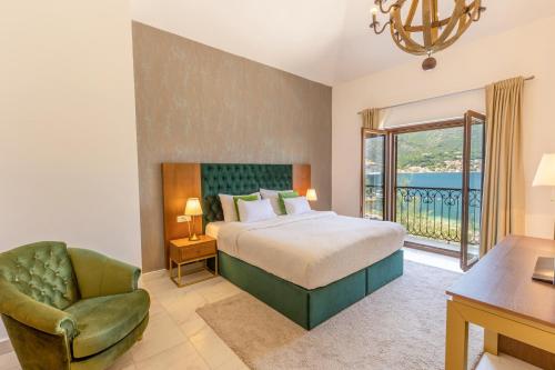 a bedroom with a bed and a desk and a chair at Kotor Bay Villas by Huma in Dobrota