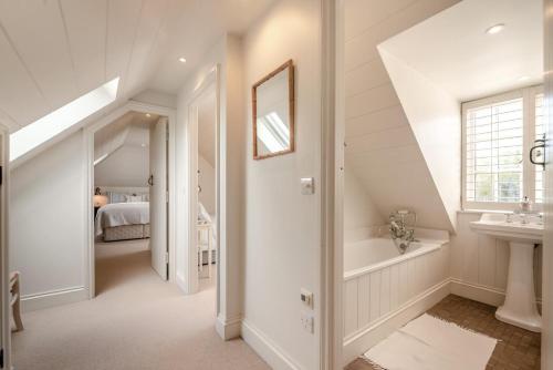 a white bathroom with a sink and a bath tub at 2 Bed in Stoke oc-c41361 in Hurstbourne Tarrant