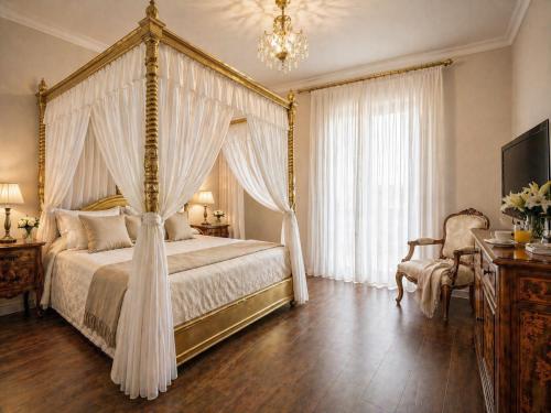 a bedroom with a canopy bed and a chandelier at Grand Hotel Vigna Nocelli in Lucera