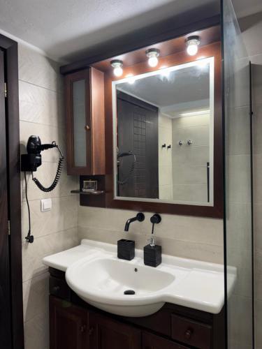 a bathroom with a sink and a mirror at Saguaro’s home Kavala in Kavála