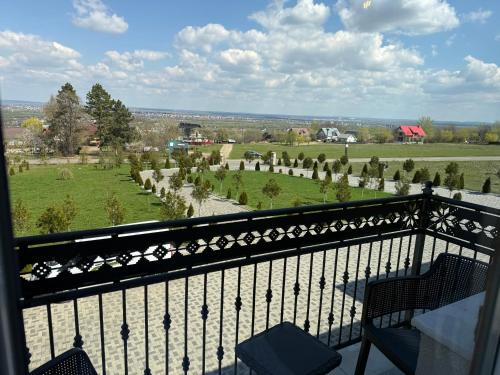 a balcony with a view of a field at GB Cazare in Volovăţ