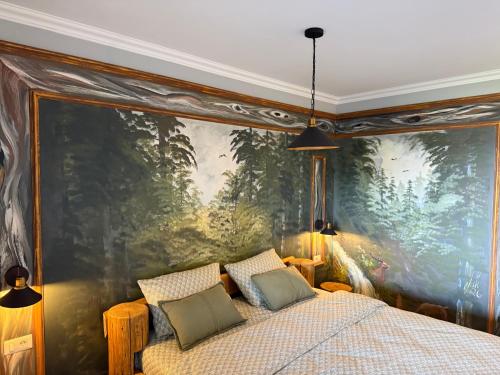 a bedroom with a large painting on the wall at GB Cazare in Volovăţ