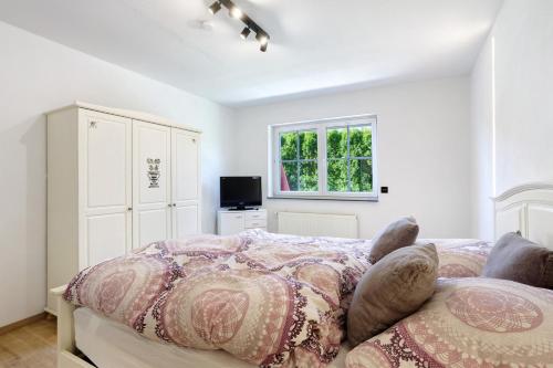 a bedroom with a bed and a window at Feriennest Balve in Balve