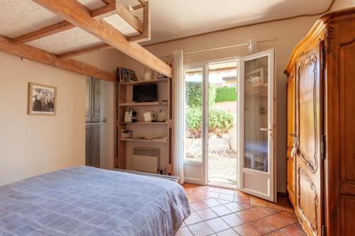 a bedroom with a bed and an open door at Chambre D'hôtes Les 5 Calanques in Ensuès-la-Redonne