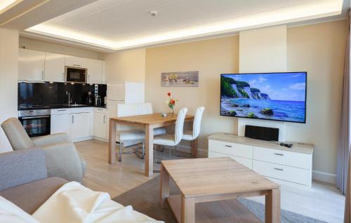 a living room with a table and a kitchen at Prince in Binz