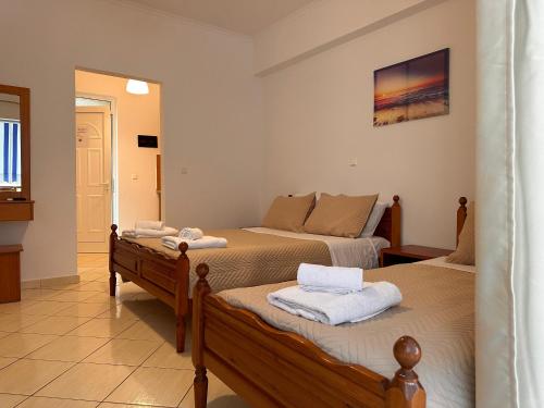 a bedroom with two beds with towels on them at Spilea Apartments in Himare
