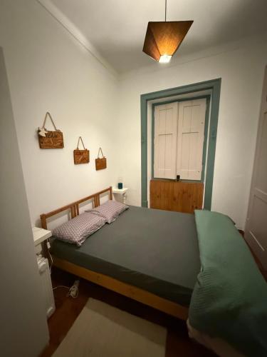 a bedroom with a bed in a room with a door at Summer Haze Ericeira in Ericeira