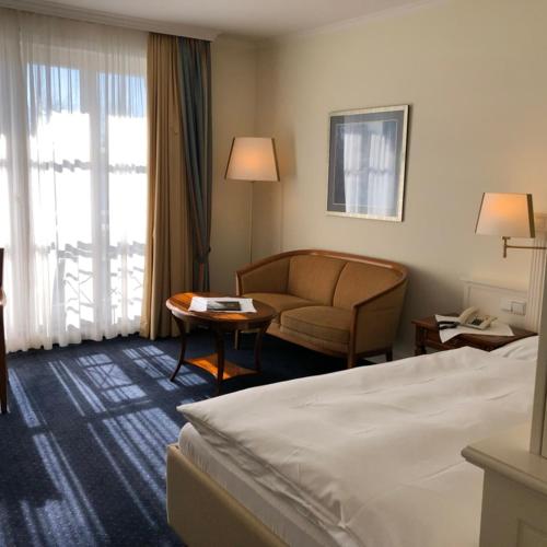 a hotel room with a bed and a couch at Hotel Scherf Residenz in Bad Lippspringe