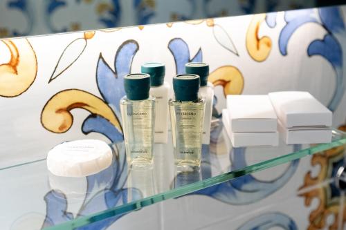 a group of bottles sitting on top of a glass table at Casa Consilla in Positano