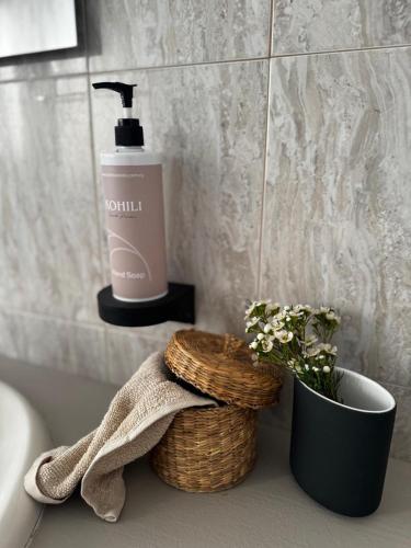 a bathroom with a bottle of soap and a plant at KOHILI Seaside Residence in Polis Chrysochous