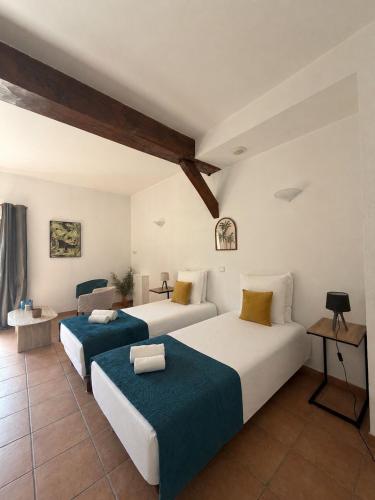 a bedroom with two beds and a couch at Golf Hotel de la Carte in Chouzy-sur-Cisse