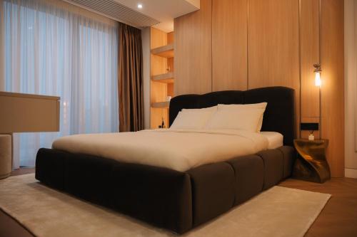 a bedroom with a large bed in a room at Designer Suite • Pool & Sauna • Pipera Metro in Bucharest