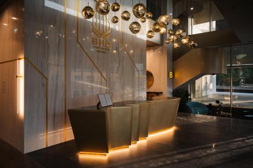 a lobby with a row of tables and chandeliers at Designer Suite • Pool & Sauna • Pipera Metro in Bucharest