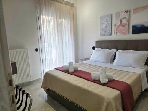 a bedroom with a large bed with towels on it at Dream Home Veria in Veria