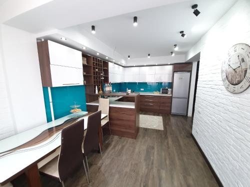 a kitchen with blue and white walls and wooden floors at Hotel Ismail in Chişinău