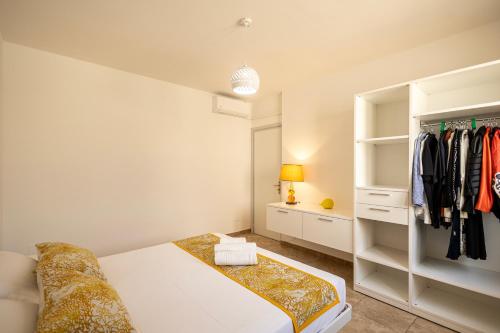 a white bedroom with a bed and a closet at Maison Gioia di Casa Camilla Journey in Capilungo