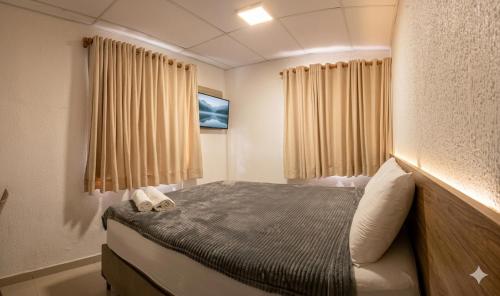 a small bedroom with a bed in a room at Hotel Porto Segur0 in Recife