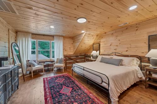 a bedroom with a bed in a wooden cabin at Riverside in Townsend
