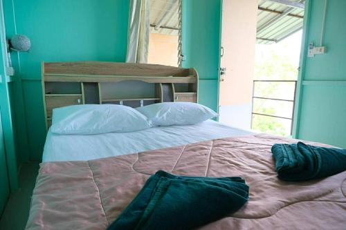 a bedroom with a large bed with blue walls at Phi Phi Oceanview Hill Bungalows in Phi Phi Islands