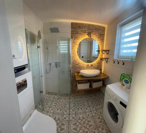 a bathroom with a sink and a shower and a toilet at Wczasy u Reni in Kopalino