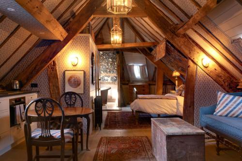 a bedroom with a bed and a table in a room at Castle Lodge in Ludlow