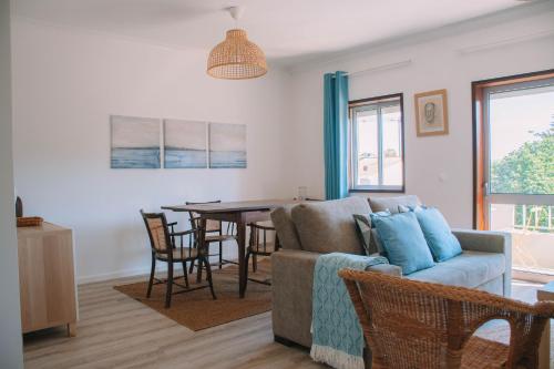 a living room with a couch and a table at Just Like Home - Retorta do Pico in Caminha