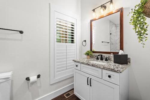 a white bathroom with a sink and a mirror at Bear Paws in Townsend