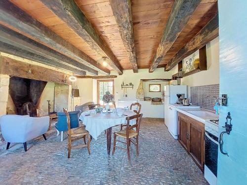 a kitchen with a table and chairs in a room at Holiday Home Le Petit Gîte by Interhome in Jayac