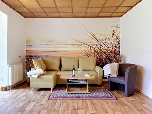 a living room with a couch and a table at Holiday Home Alexorella by Interhome in Godern