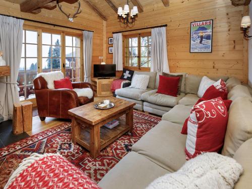a living room with couches and a table at Chalet Saint Piran-1 by Interhome in Villars-sur-Ollon