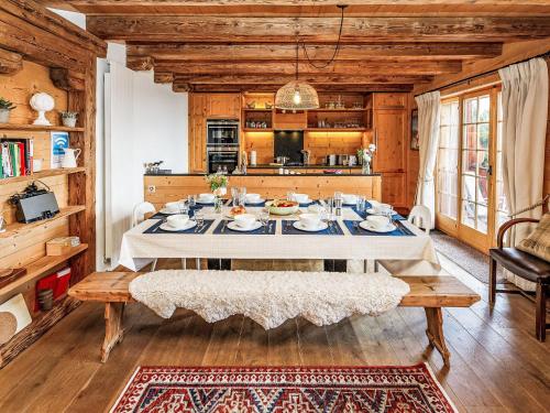 a dining room with a table and a kitchen at Chalet Saint Piran-1 by Interhome in Villars-sur-Ollon