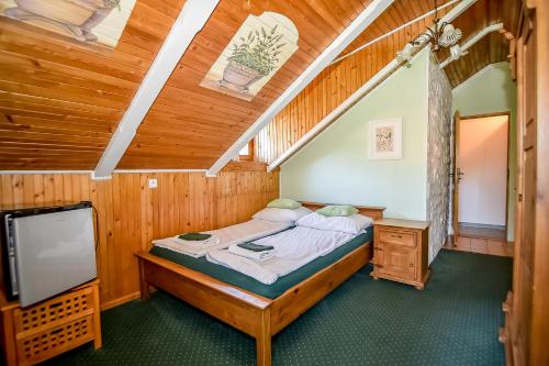 a bedroom with a bed and a flat screen tv at Villa Cynamon Jacuzzi & Sauna in Wisła