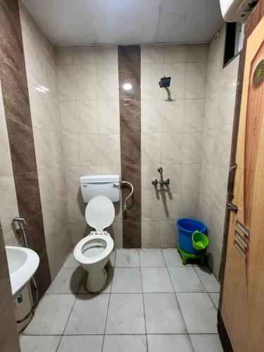 a bathroom with a toilet and a sink at Hotel Crystal Inn in Lucknow