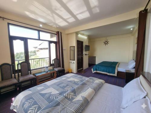 a hotel room with a bed and a window at The Smarthill Sanctuary in Dalhousie