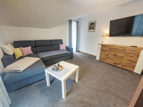 a living room with a couch and a tv at Apartment Haus Toferer by Interhome in Grossarl
